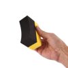 Black and yellow foam curved applicator for tyres being grasped by a hand.
